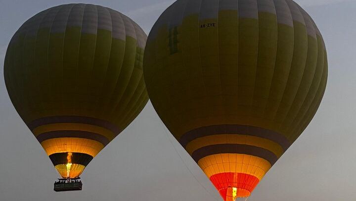 Gliding through the golden dusk — a magical hot air balloon ride above the desert evening sky