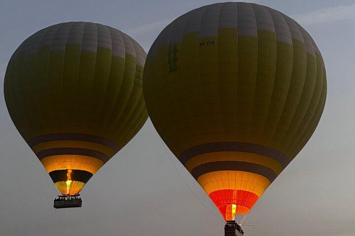 Gliding through the golden dusk — a magical hot air balloon ride above the desert evening sky