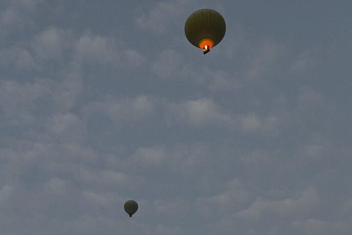 Hot air balloon floating gently in the evening sky — a stunning view above the serene Dubai desert.