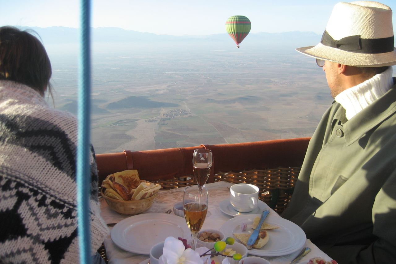 A hot air balloon flying over open ground outside Marrakech, Morocco