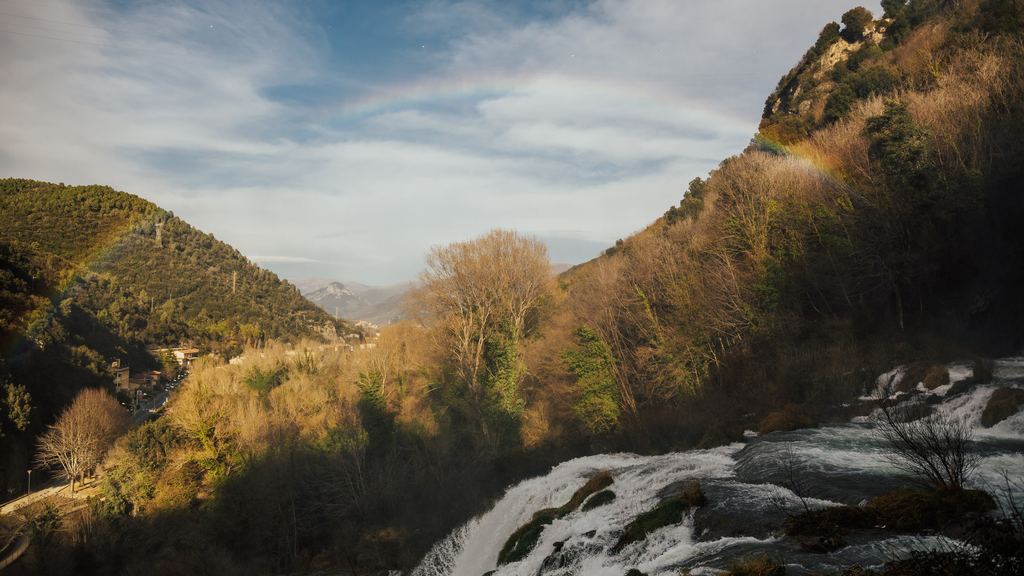 The Marmore falls near Terni, water dropping through wooded limestone with a rainbow in the spray