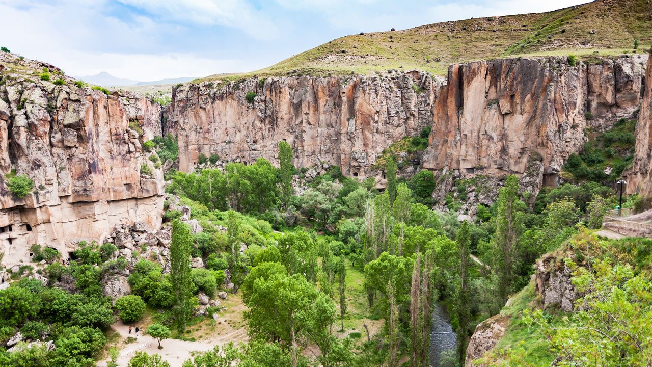 The green floor of the Ihlara Valley seen from the rim, with the Melendiz stream running between rock walls, southwest of Göreme in Cappadocia