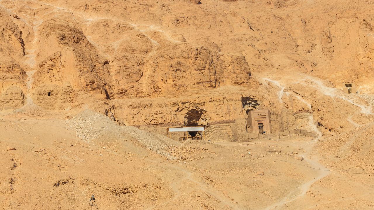 Rock-cut tomb entrances in the hills of the Theban necropolis, a few minutes' drift from the launch fields.