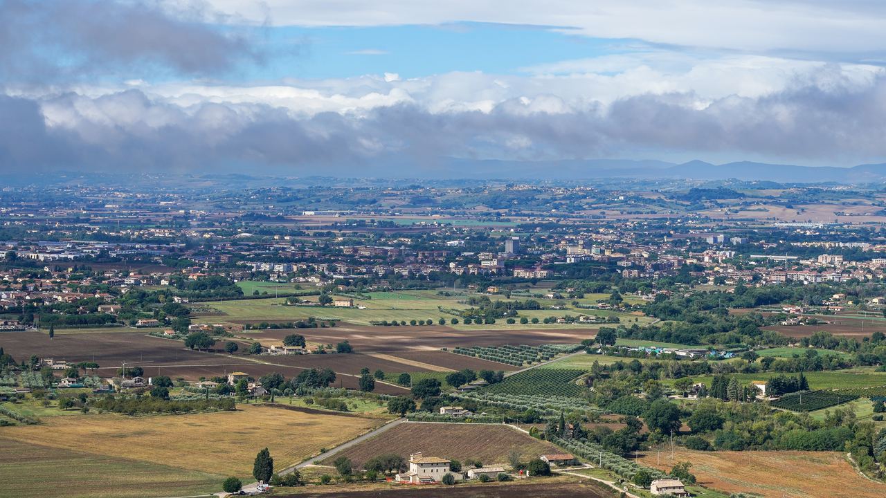 The Valle Umbra from Assisi: the drained lake floor that gives balloons their launch and landing ground.